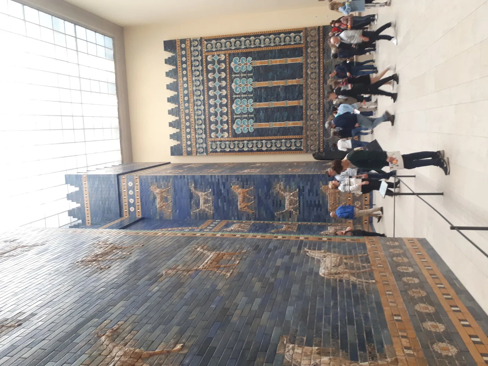 Monumental gateway faced in deep blue glazed brick, decorated with rows of moulded bulls and dragons in gold and white.