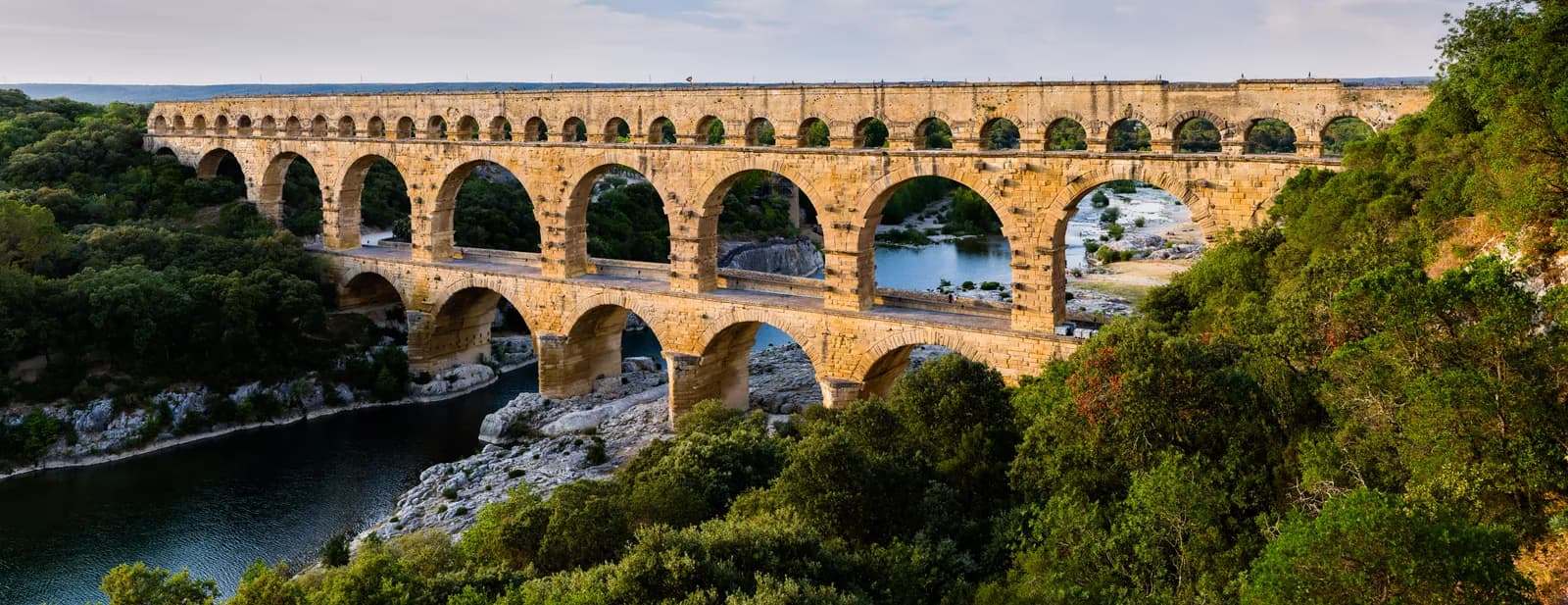 The Pont du Gard, a three-tiered Roman aqueduct bridge spanning the river Gardon in southern France, built in the first century CE as part of the aqueduct carrying water some fifty kilometres to the city of Nîmes.