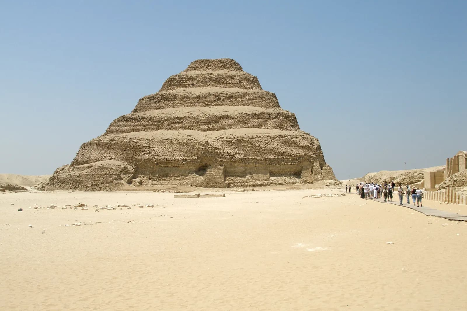 The six-stepped Step Pyramid of Djoser rising in tiers above the desert at Saqqara — the world's earliest large stone building.