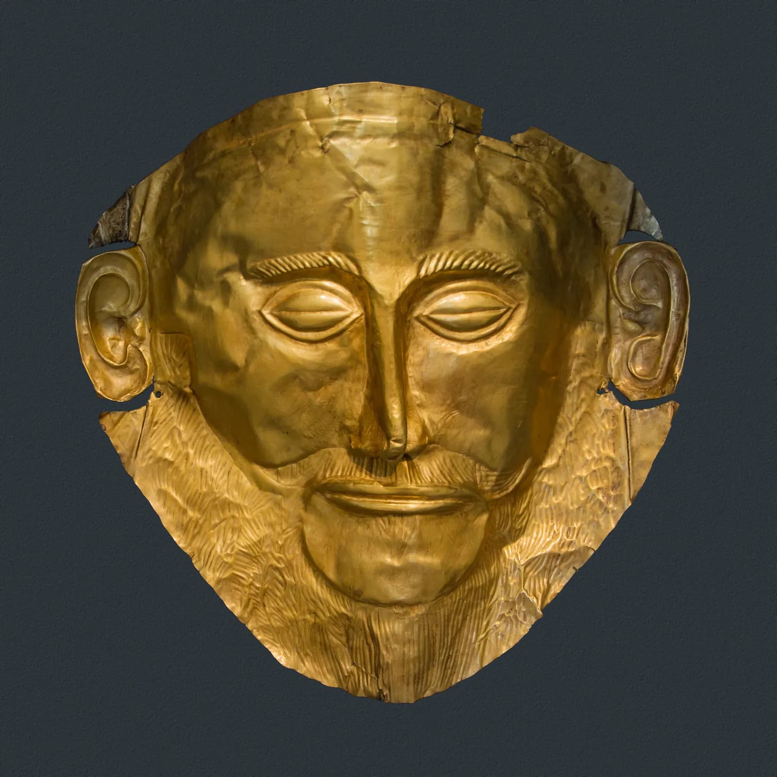 Beaten gold funerary mask of a bearded man with closed eyes, from a shaft grave at Mycenae.