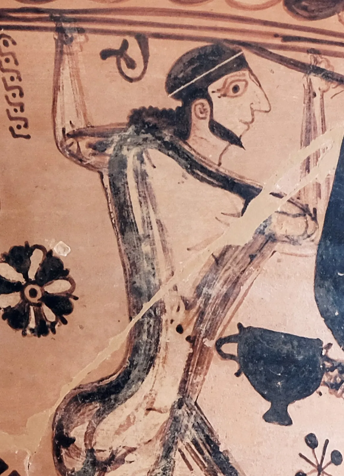 Detail of a large painted amphora showing three figures driving a long pointed stake into the single eye of a seated giant.