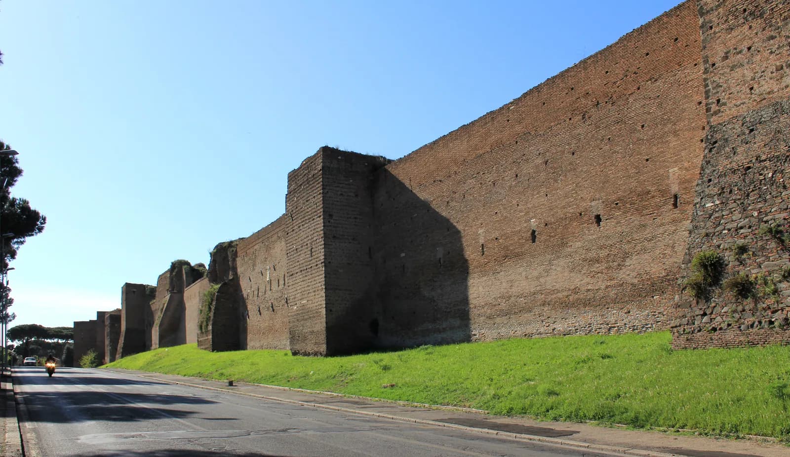 A standing brick-faced section of the Aurelian Walls of Rome, the defensive circuit begun under the emperor Aurelian in the 270s CE to enclose and protect the imperial capital.