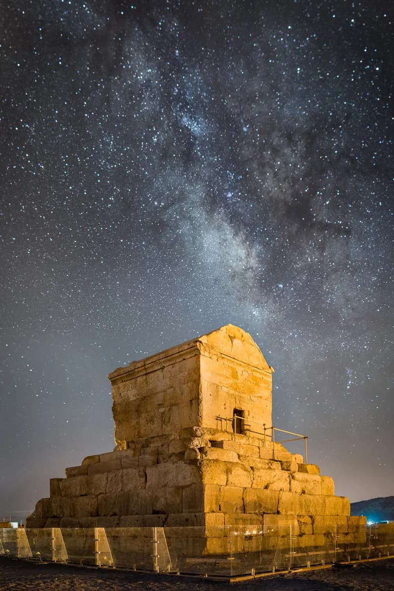 The free-standing stepped limestone tomb of Cyrus the Great at Pasargadae, c. 530 BCE — a gabled chamber on a six-tiered plinth, the burial place of the founder of the Achaemenid empire.