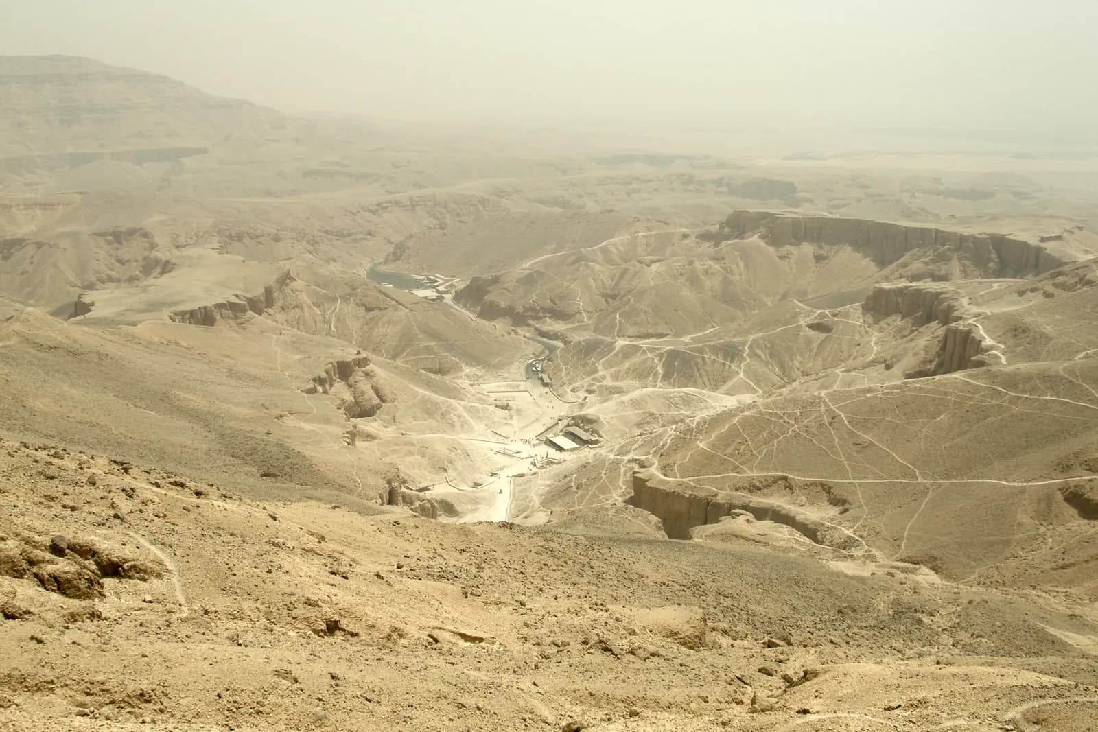 Panoramic view of the arid, cliff-walled Valley of the Kings, the burial ground of the New Kingdom pharaohs, with tomb entrances cut into the rock.